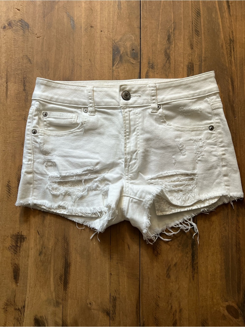 White Distressed Denim Cutoff Shorts with Embroidered Pockets